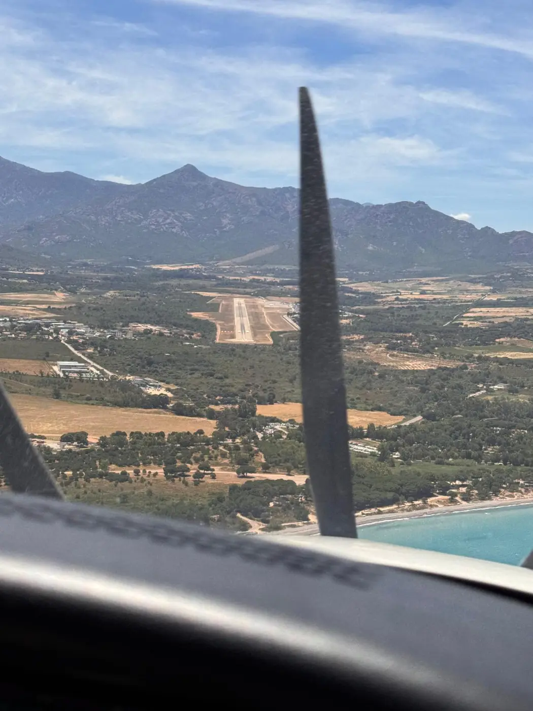 Short final at Calvi with mountains behind the runway